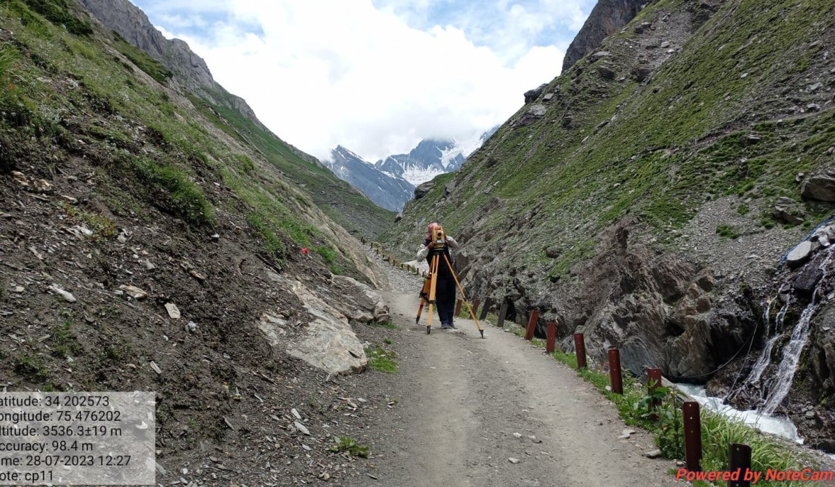 Topographic survey team working in tough hilly terrain during catchment and cross-section survey for a bridge hydrology report